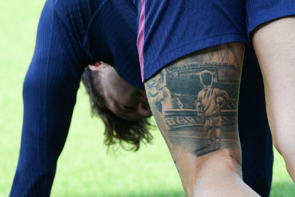 a man with a tattoo on his arm that says barça