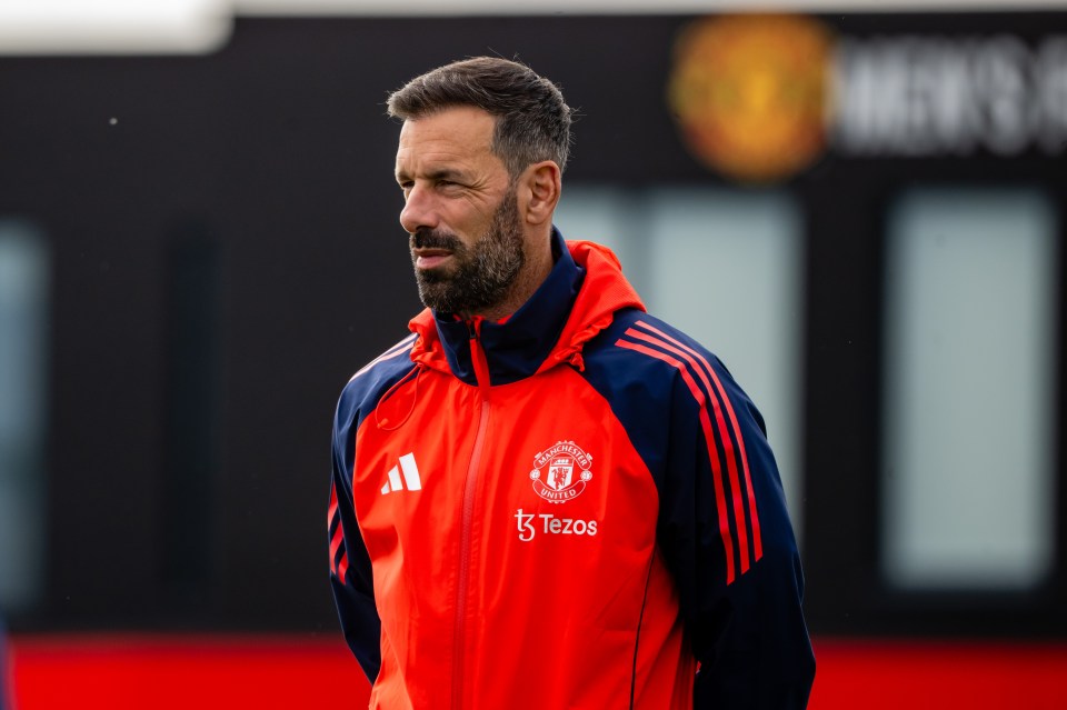 a man wearing a red manchester united jacket