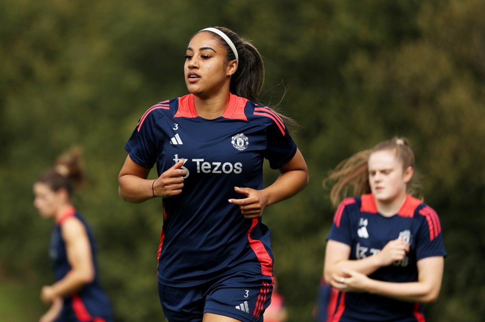 a female soccer player wearing a tezos jersey