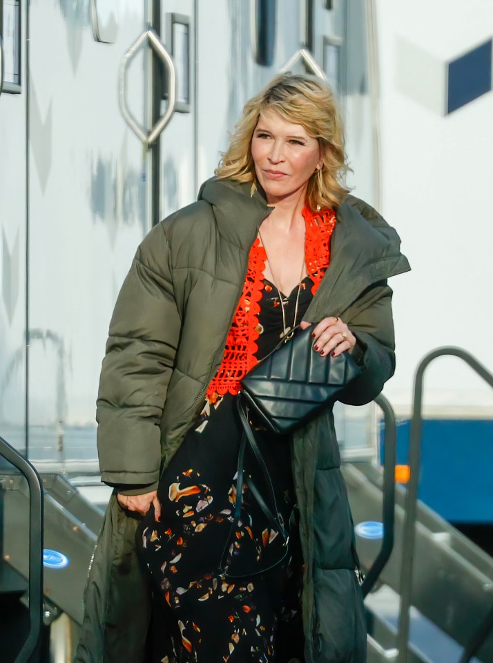 Julia Davis donned wedding attire under her big puffy coat