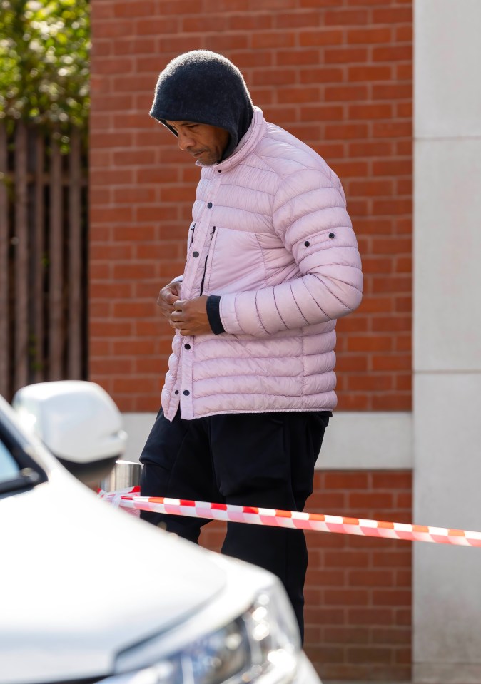 The TV presenter kept his head down as he walked to a car