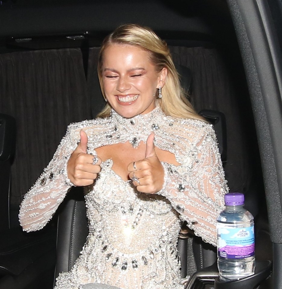 a woman giving a thumbs up next to a bottle of aquafina water