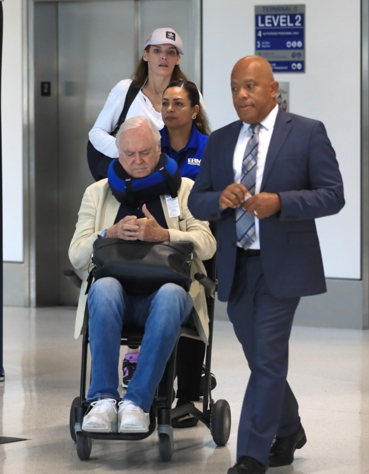 John Cleese was spotted busy on his phone after landing at LAX