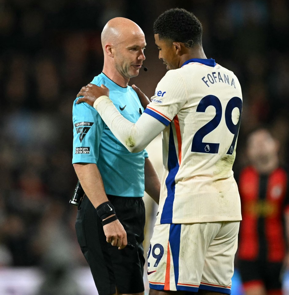 a soccer player with the number 29 on his jersey talks to a referee