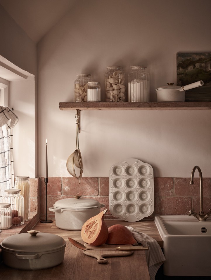 a kitchen counter with pots and pans on it