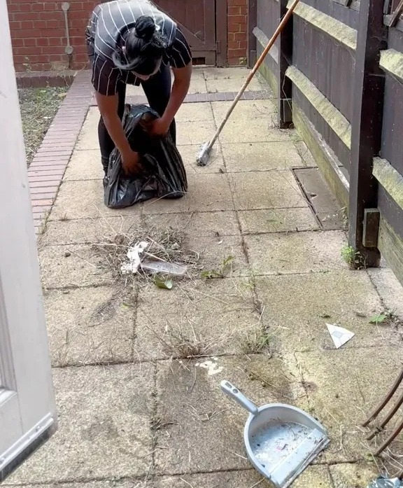 She places the bin bag over her shoes and pulls it to form her own bucket