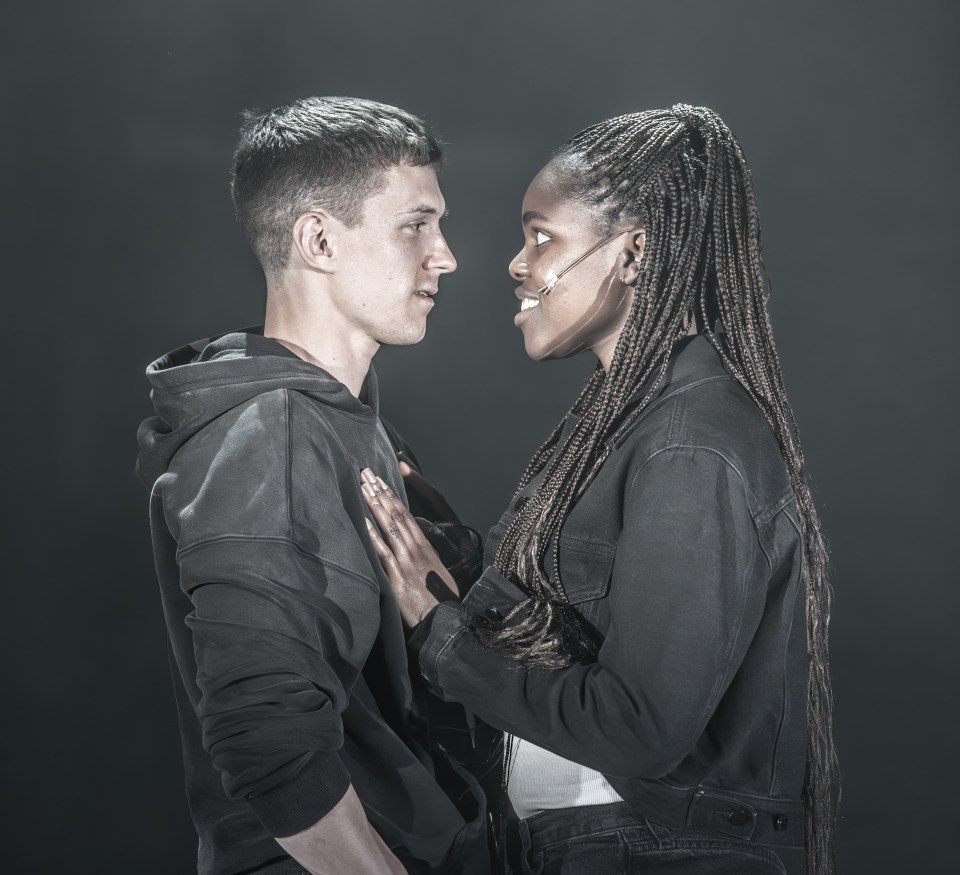 a man and a woman are looking at each other in a dark room