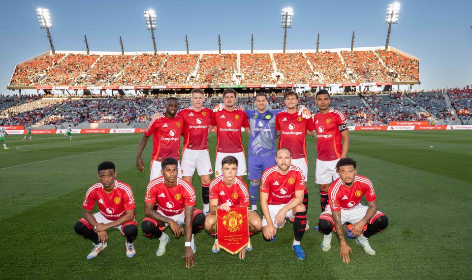 a group of soccer players pose for a team photo