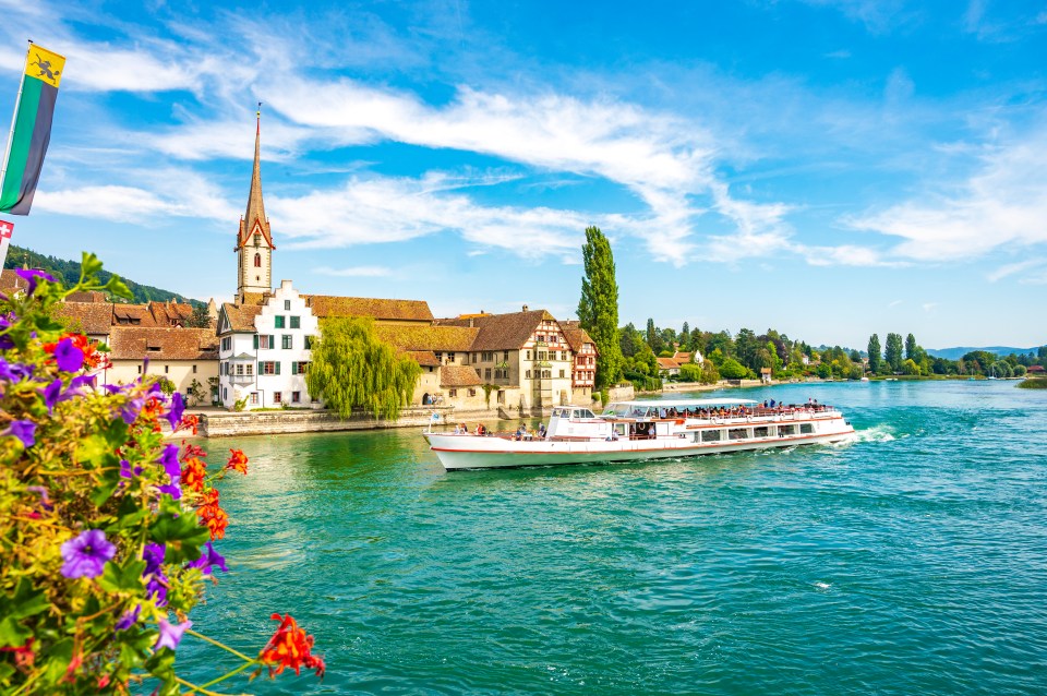 a boat in the water with a church in the background