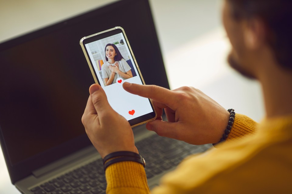 a man is holding a cell phone with a picture of a woman on it