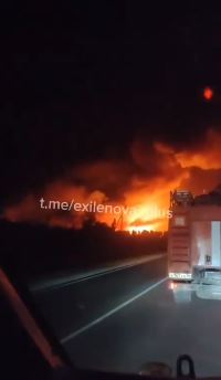 a fire truck is driving down a highway at night .