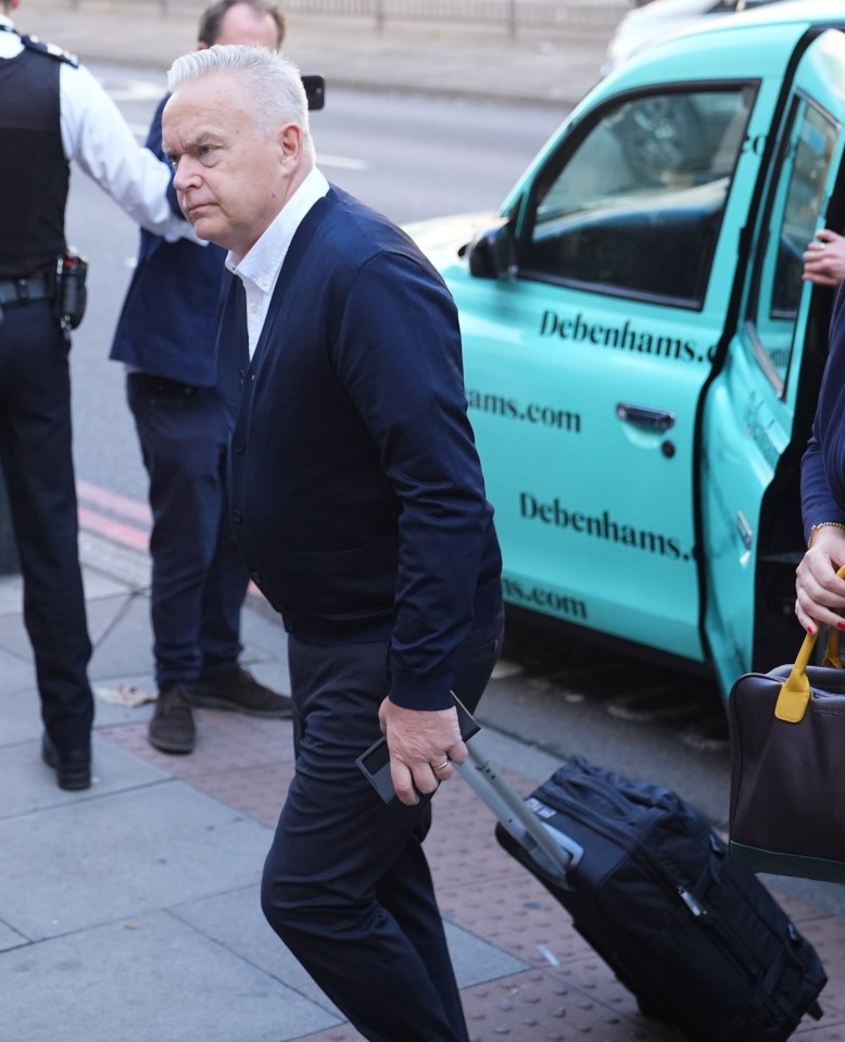 a man is walking towards a debenhams car