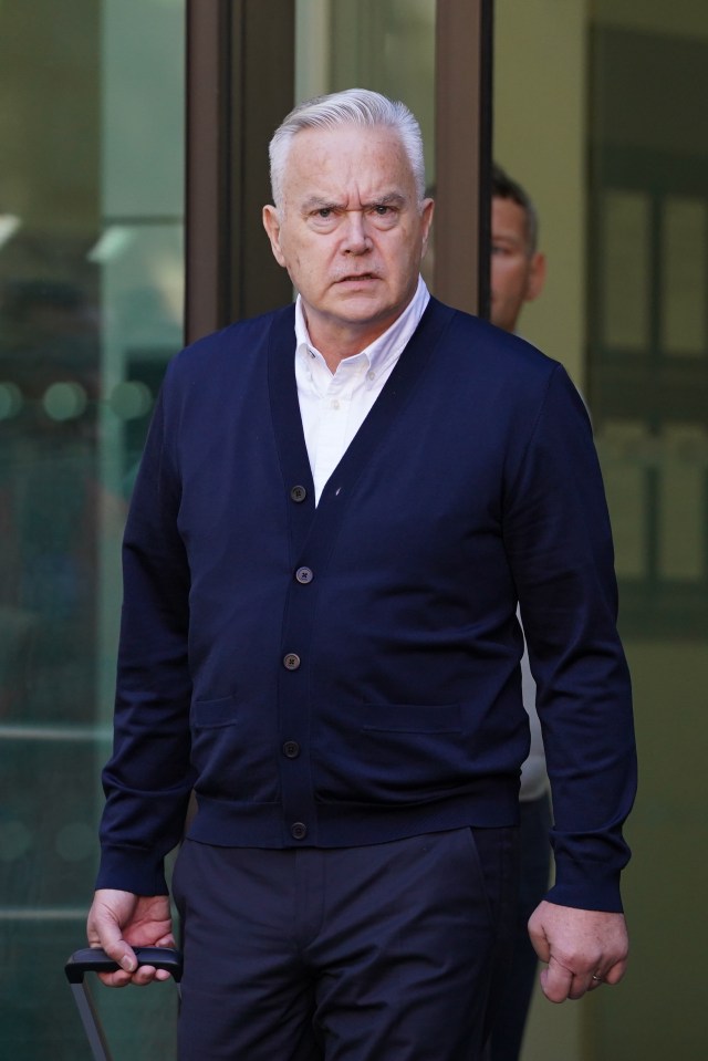 a man wearing a blue cardigan and a white shirt