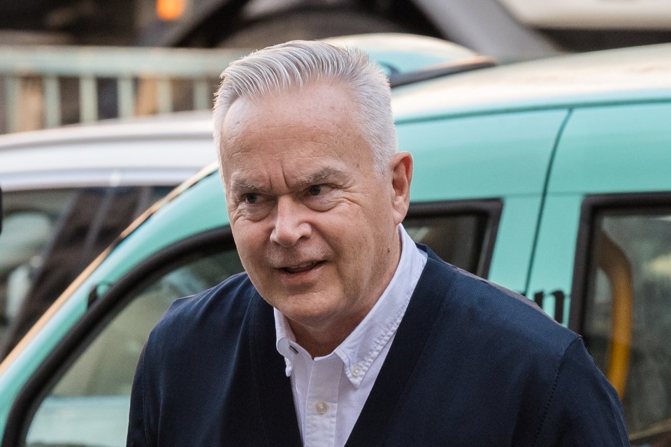 a man with gray hair is standing in front of a green van