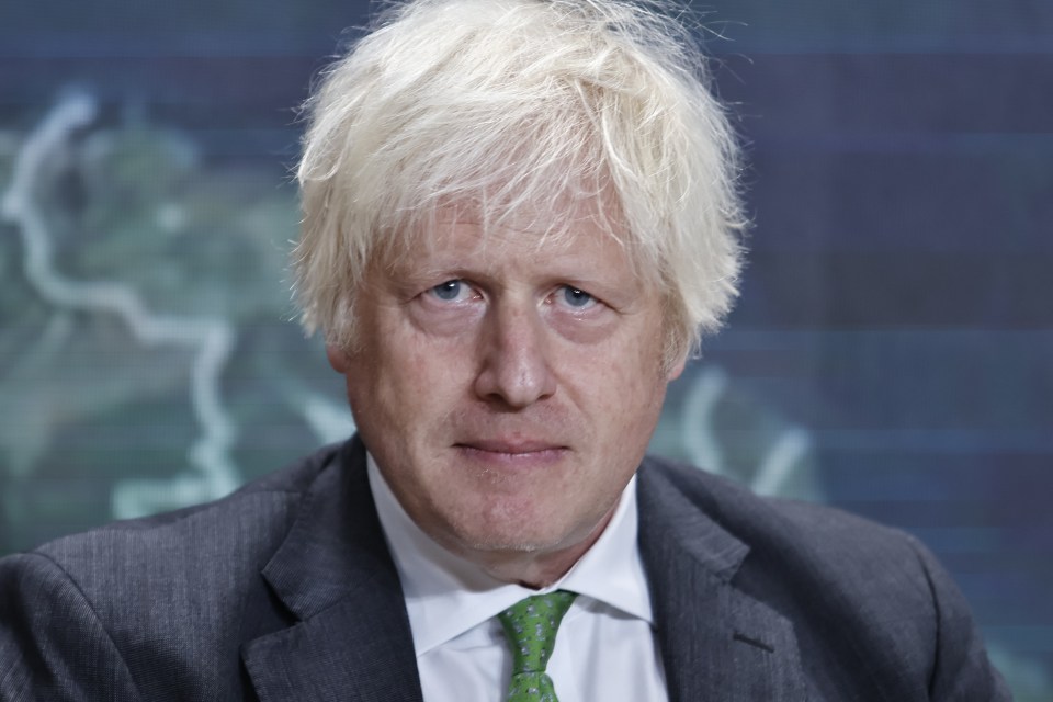 a man with blonde hair is wearing a suit and tie