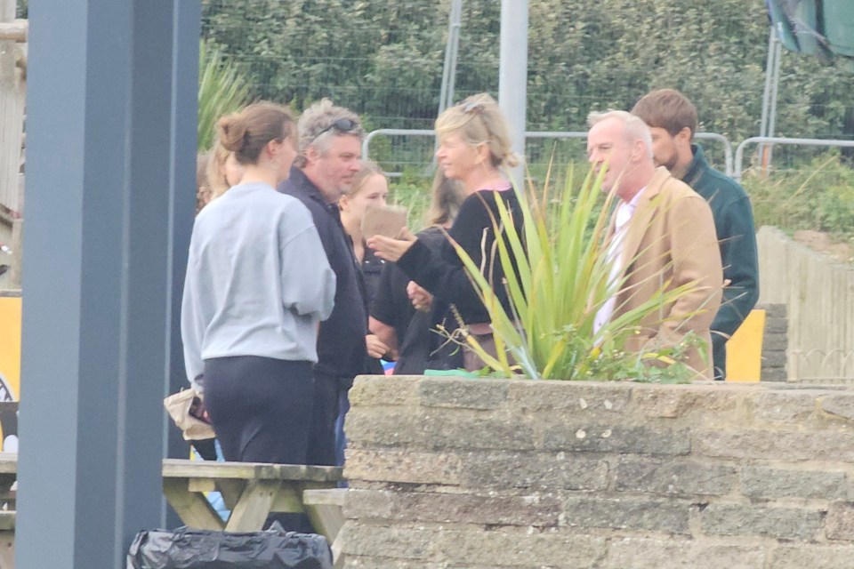 Zoe mingled with the group at a beach cafe