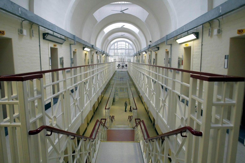 a long hallway in a prison with the number 42 on the wall