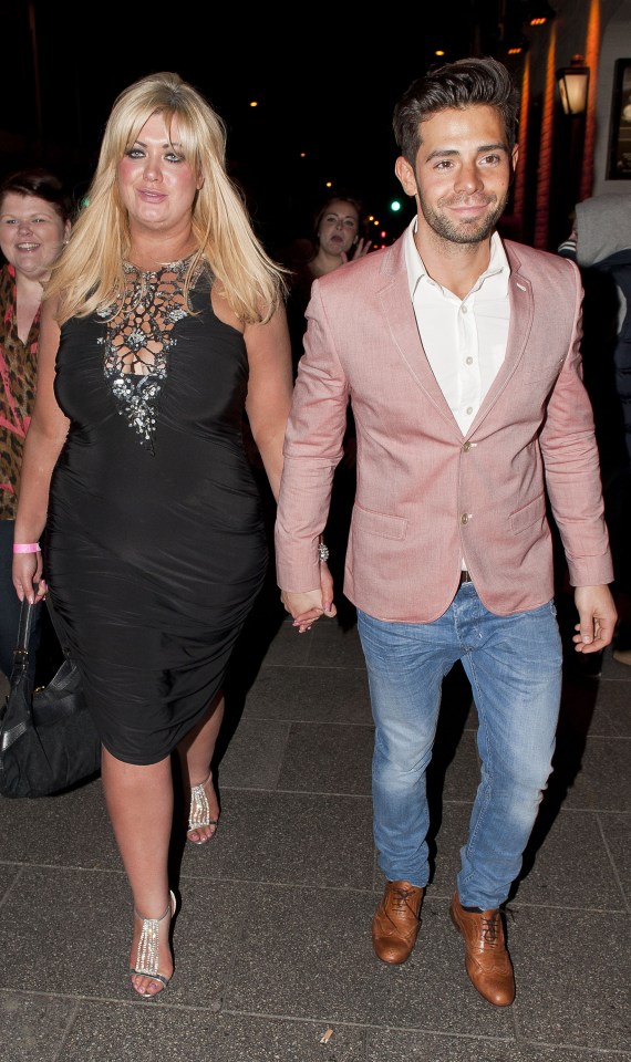 a woman in a black dress holds hands with a man in a pink jacket