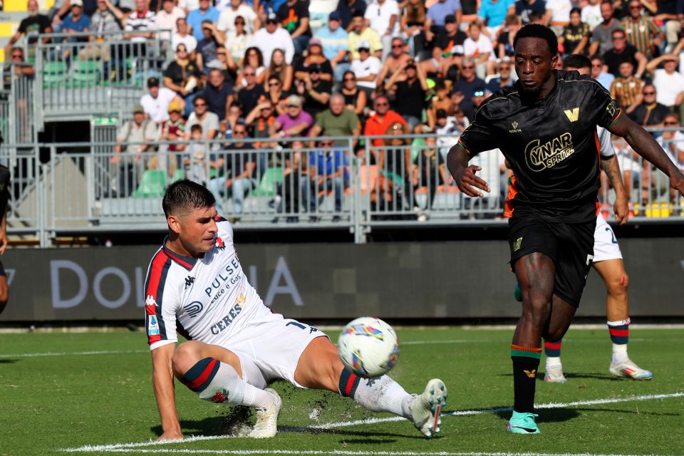 a soccer player wearing a ceres jersey kicks the ball