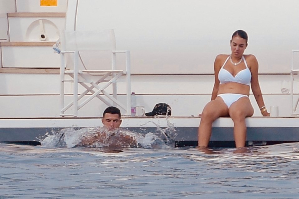 a man and a woman are sitting on a boat in the water