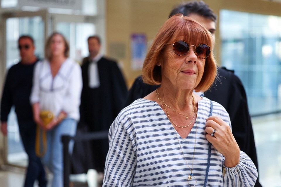 an older woman wearing sunglasses and a striped shirt