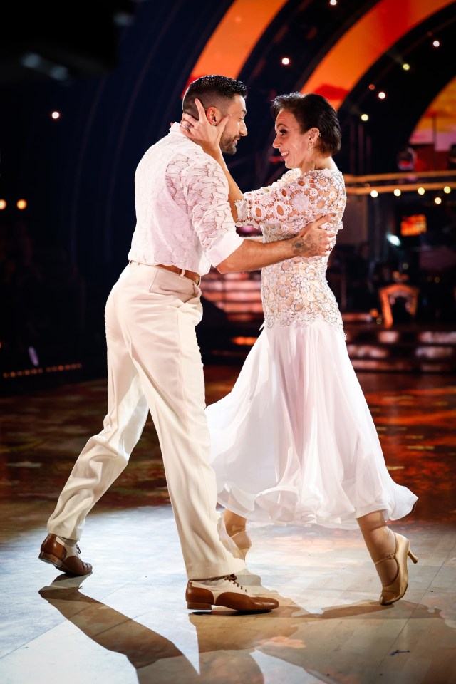 a man and a woman are dancing on a dance floor