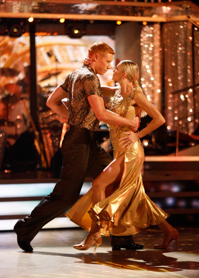 a man and a woman are dancing on a stage