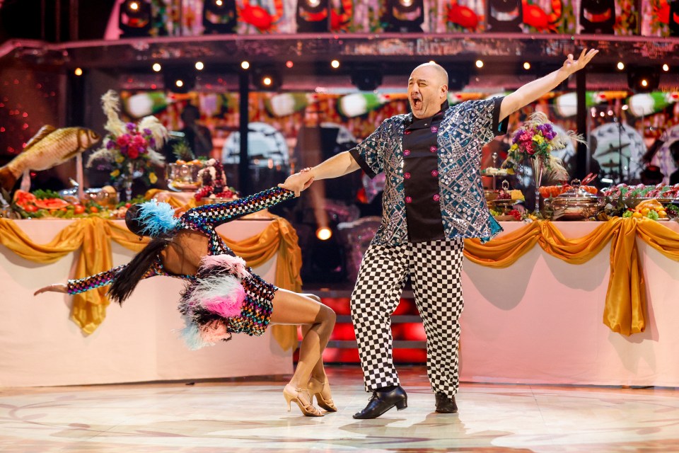 a man and a woman are dancing on a stage