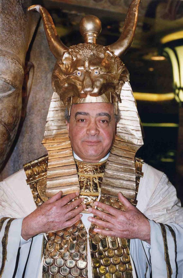 a man wearing a gold costume with a lion 's head on top