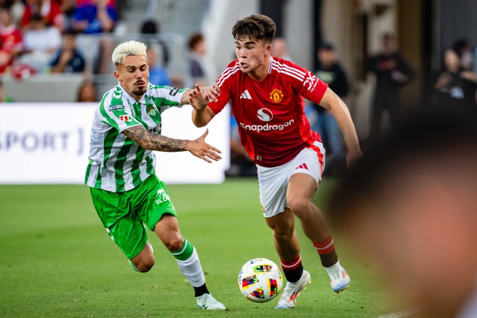 a man in a red snapdragon jersey is playing soccer