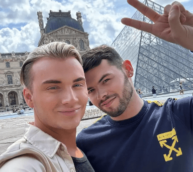 two men posing for a picture with one wearing a shirt that says off white