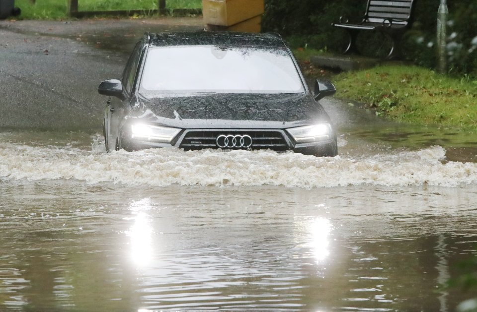 A car braves floodwater in Bedfordshire this morning