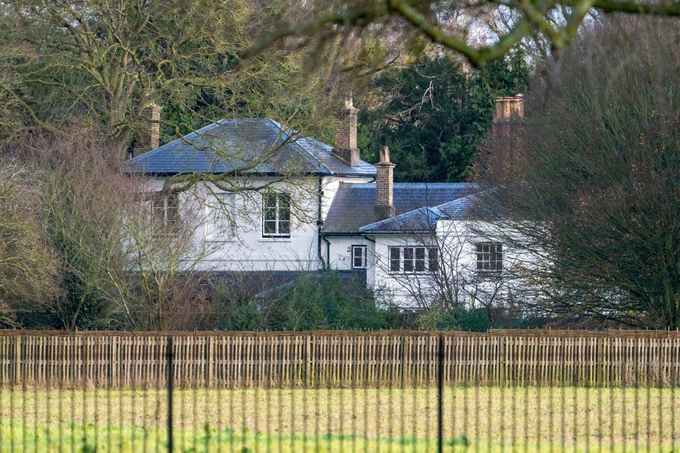 a white house with a fence in front of it