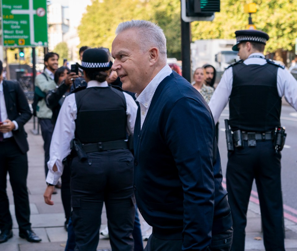 a group of police officers are standing around a man