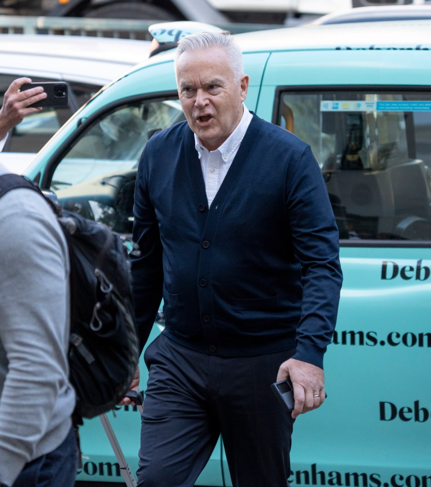 a man standing in front of a car that says deb