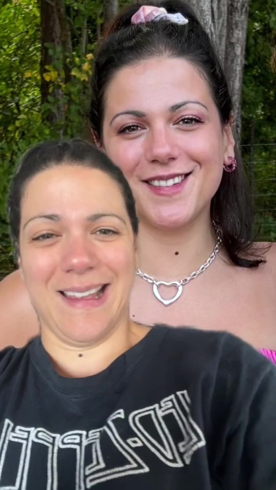 two women are posing for a picture and one is wearing a t-shirt that says tissot