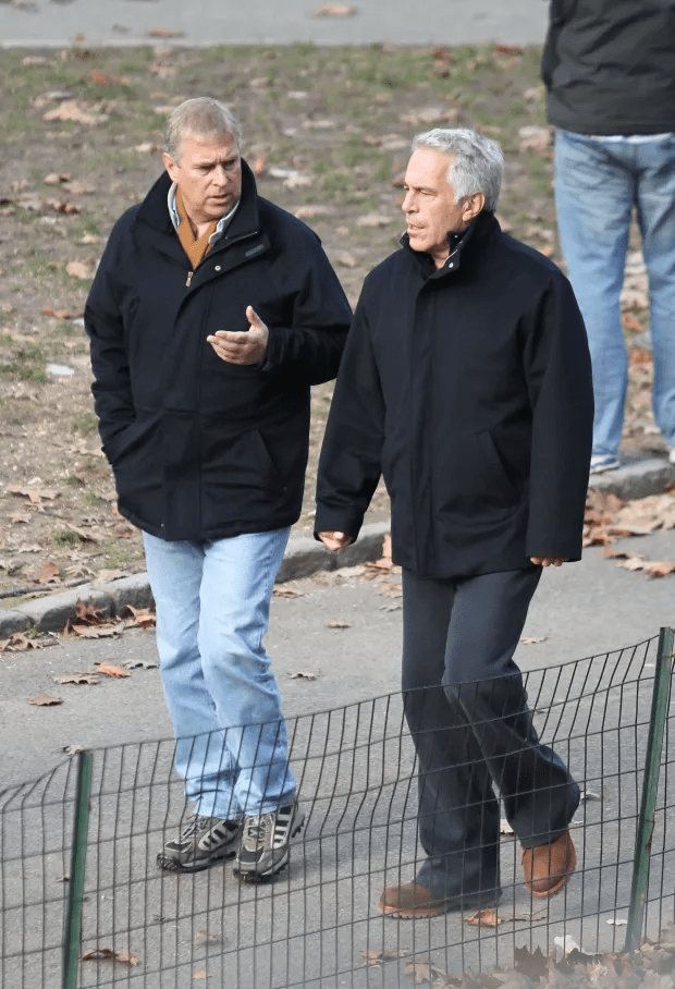 two men standing next to each other with one wearing a black jacket