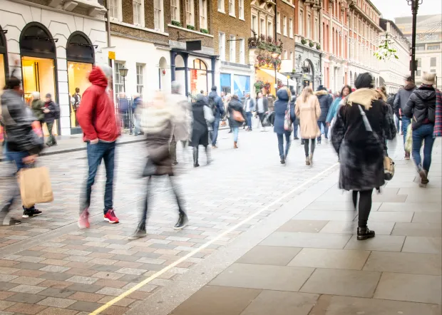 a blurry picture of people walking down a city street