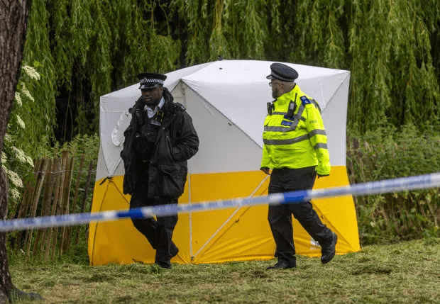 two police officers in front of a yellow and white tent