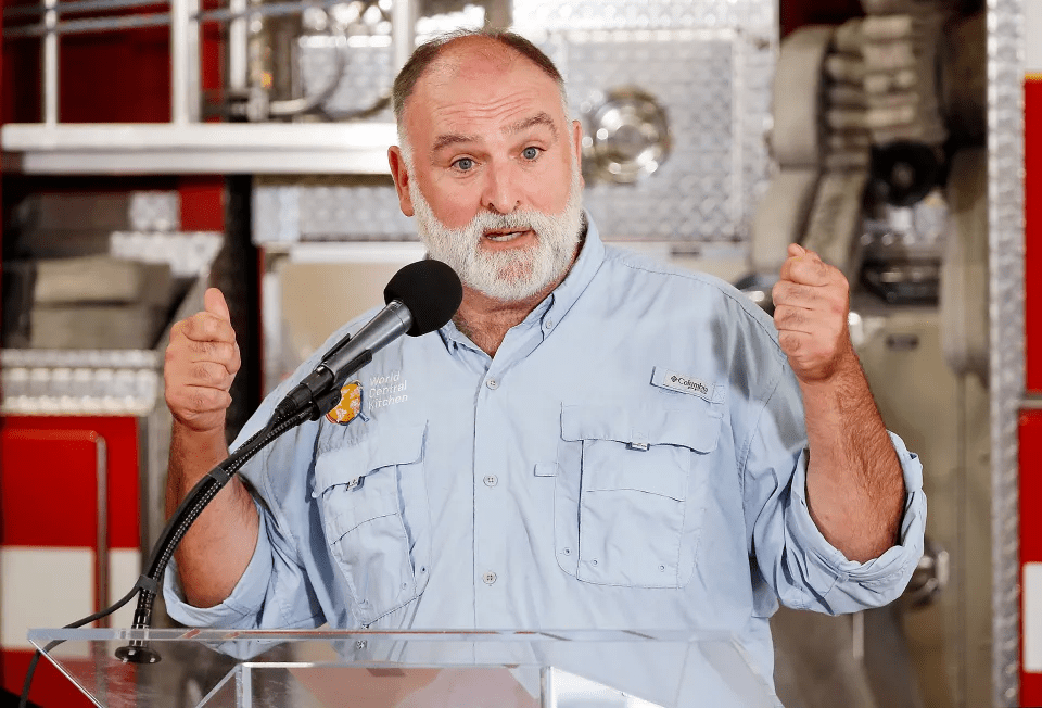 a man wearing a columbia shirt is speaking into a microphone