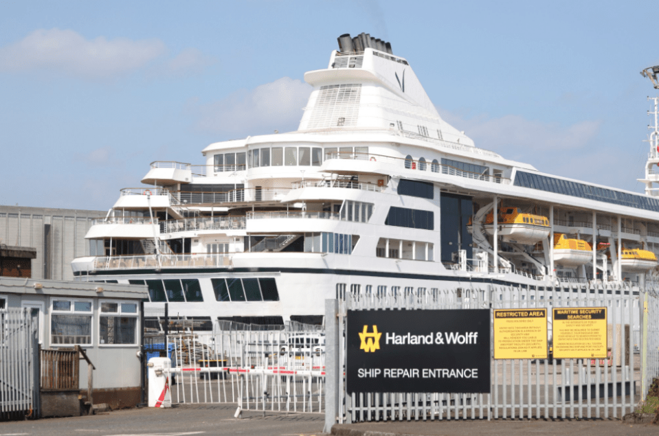 a harland & wolff ship repair entrance is behind a fence