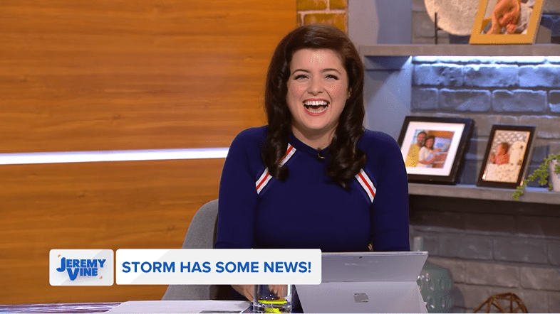 a woman sitting at a desk with a sign that says storm has some news