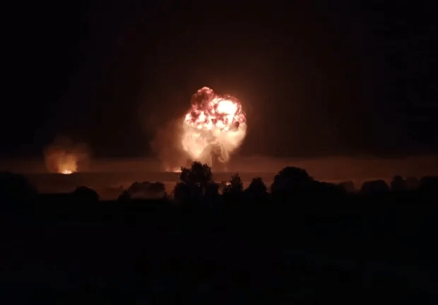 Incredible footage shows the ammo depot exploding in a mushroom fireball