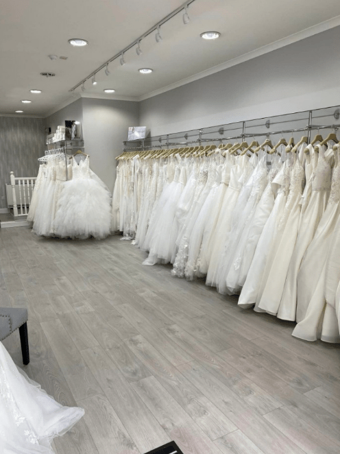 a store filled with lots of white wedding dresses