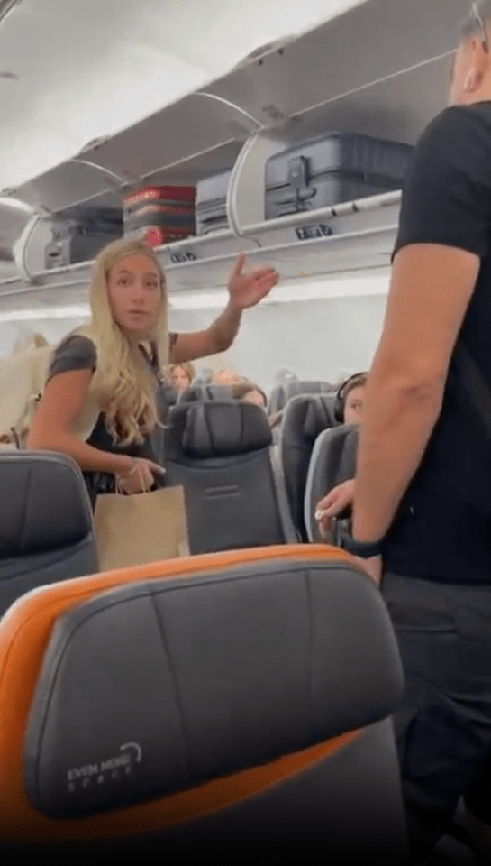 a woman is talking to a man on an airplane that says even more space