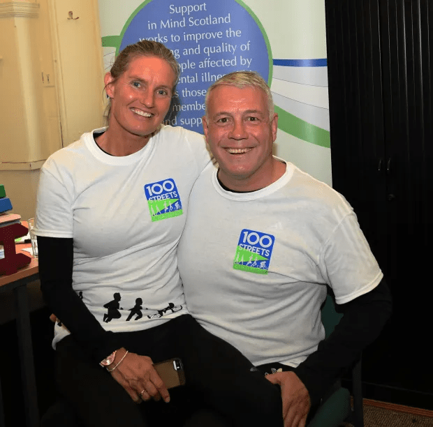 a man and a woman wearing 100 streets t-shirts