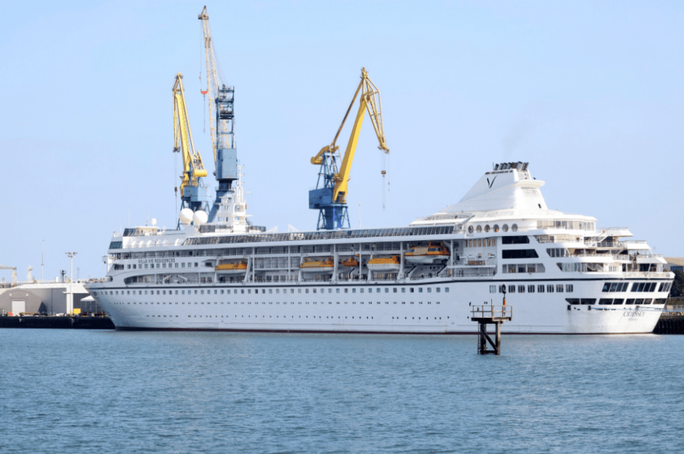 a large white cruise ship is docked in the water