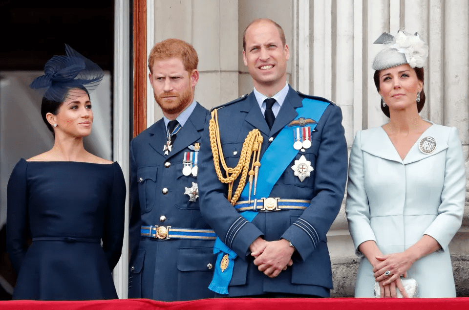 a group of people standing next to each other with one wearing a blue dress