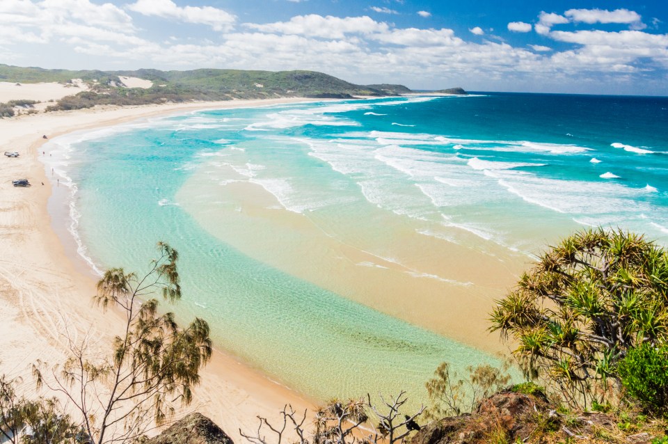 a beach with a lot of waves coming in