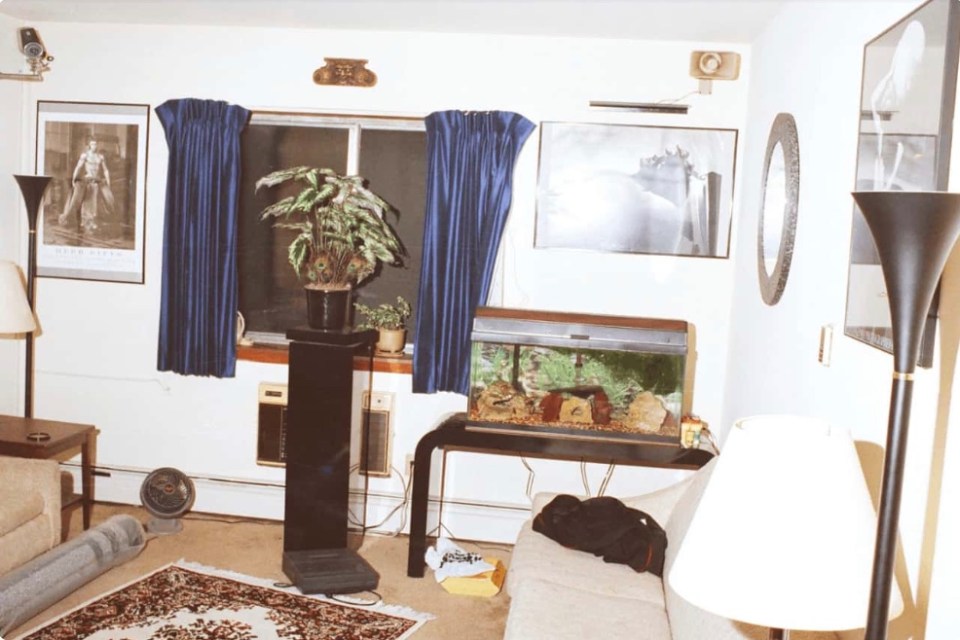 a living room with a couch and a fish tank